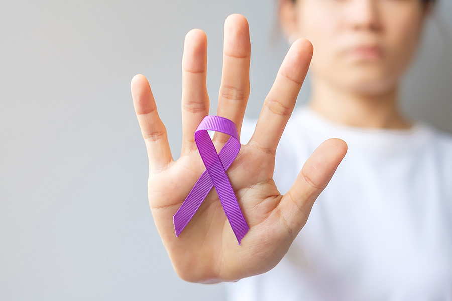 Woman palming purple ribbon