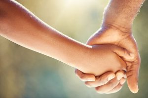 Man holding young child's hand